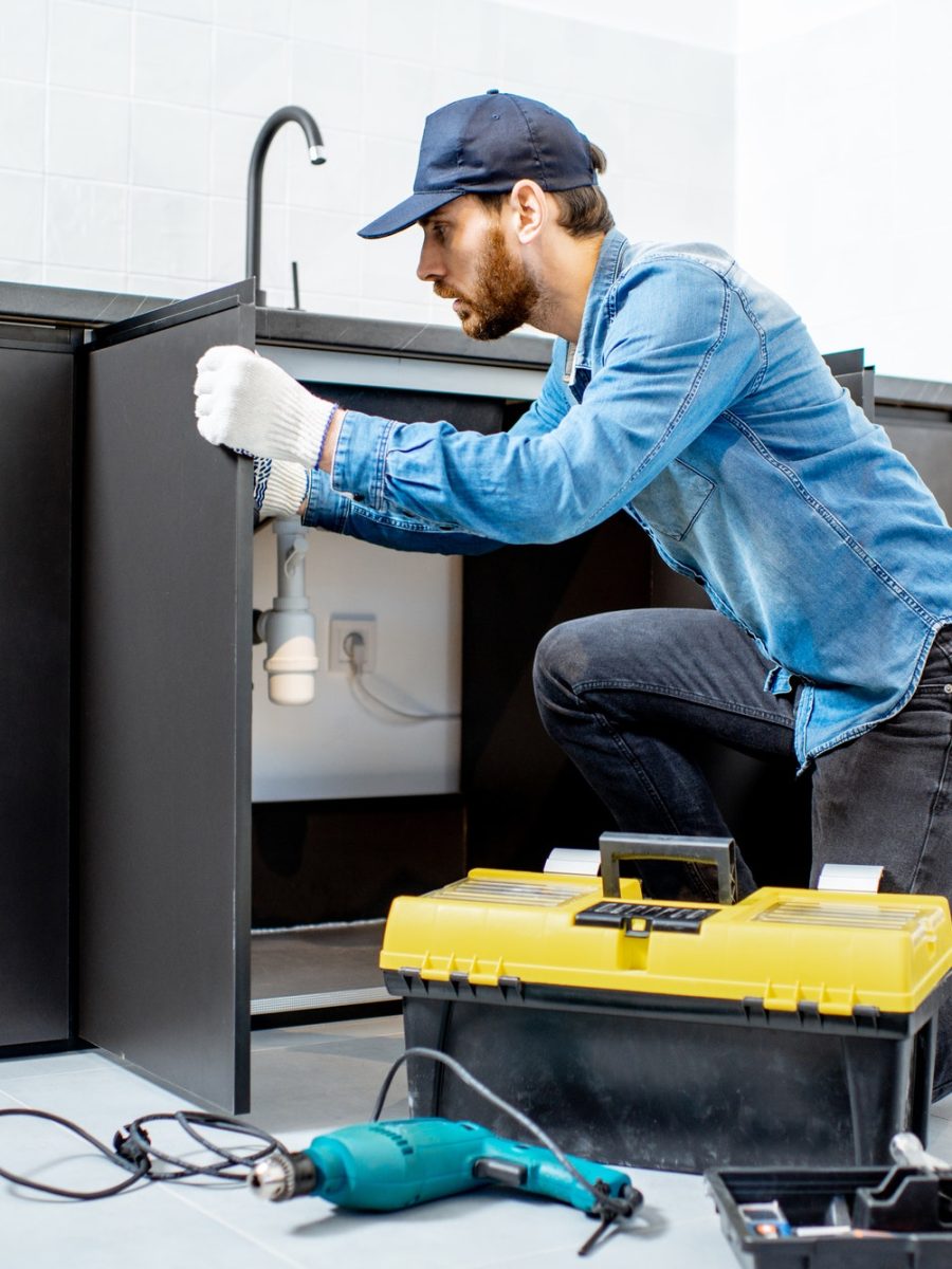 Man repairing kitchen furniture